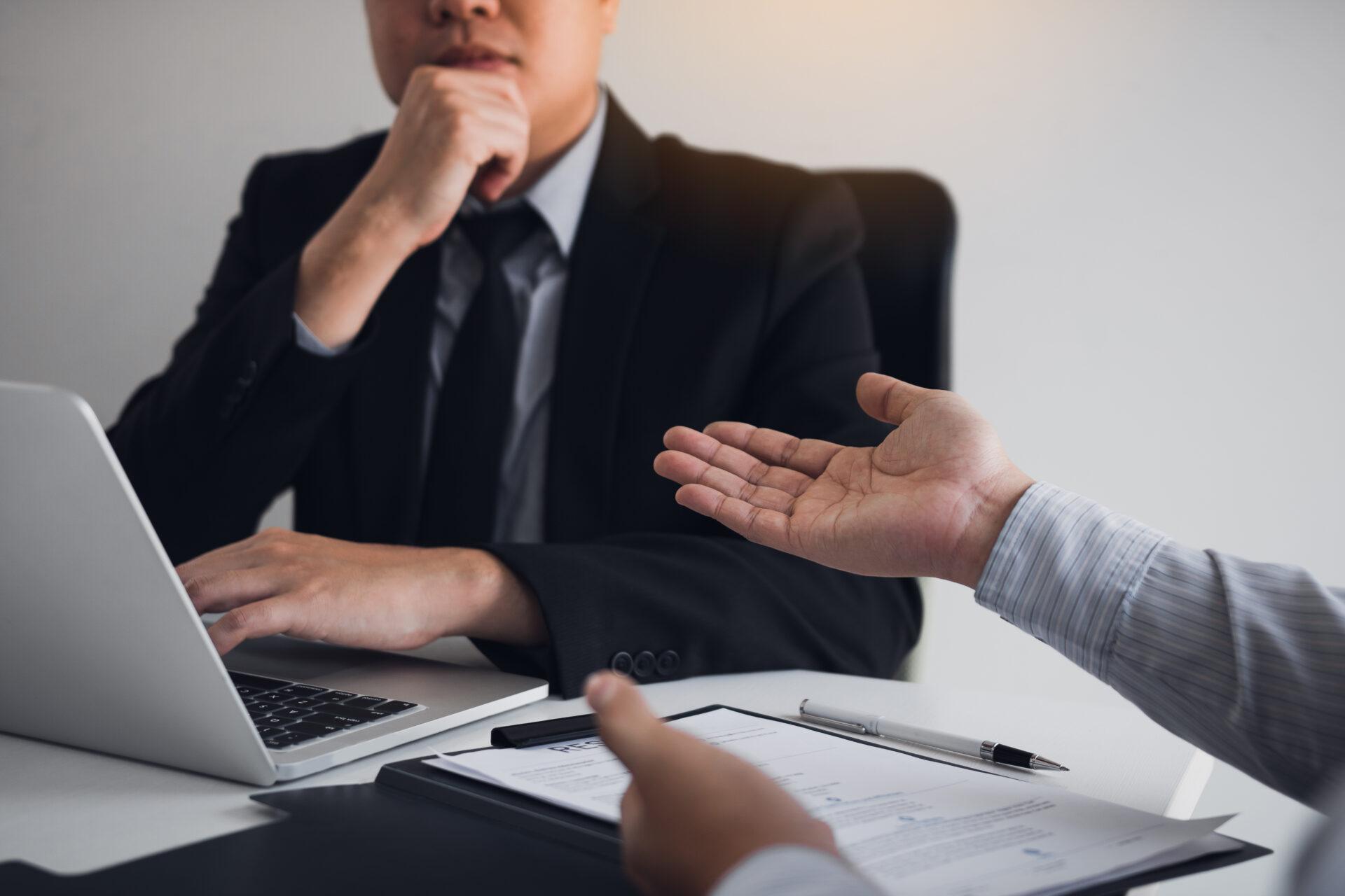 Serious asian businessman important conversation with male emplo Serious asian businessman important conversation with male employee are reviewing resume documents.